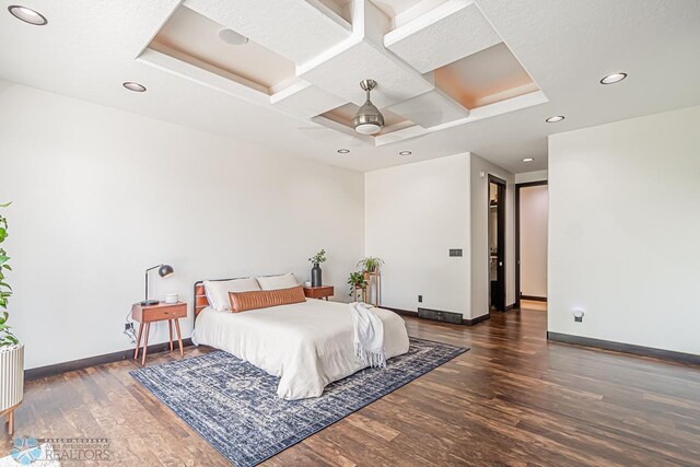 bedroom with coffered ceiling, ceiling fan, and dark wood-type flooring