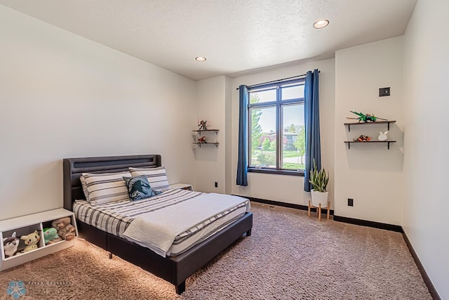 bedroom with a textured ceiling and carpet