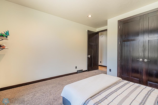 carpeted bedroom with a closet