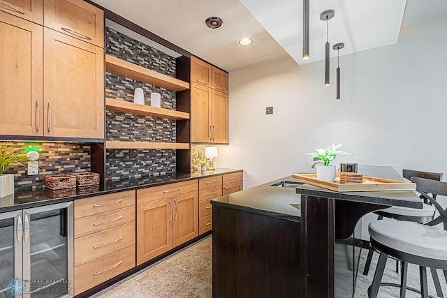 kitchen with beverage cooler, tasteful backsplash, dark stone countertops, light tile floors, and hanging light fixtures