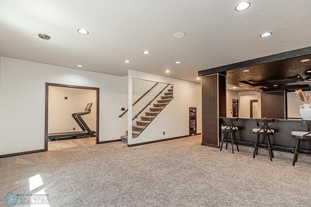 interior space featuring indoor bar and a textured ceiling