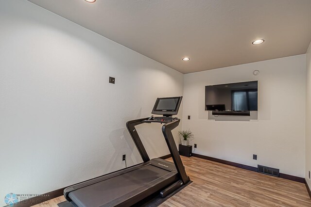 exercise area featuring light hardwood / wood-style floors