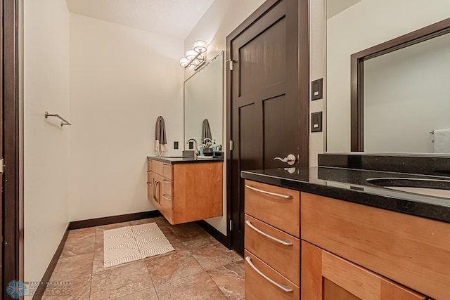 bathroom with tile flooring and vanity