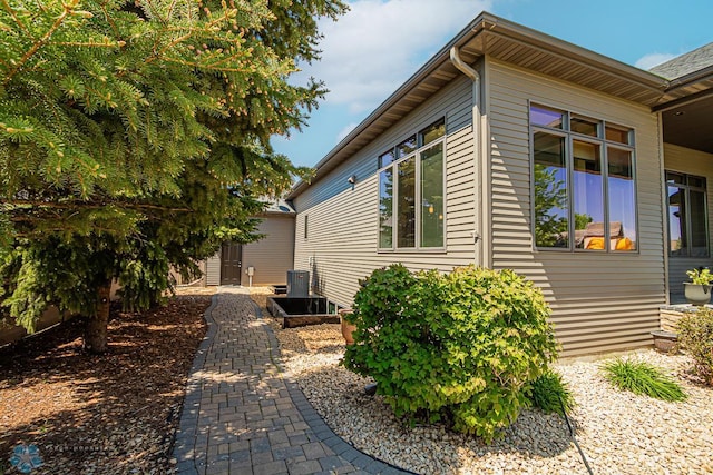 view of side of property with central AC