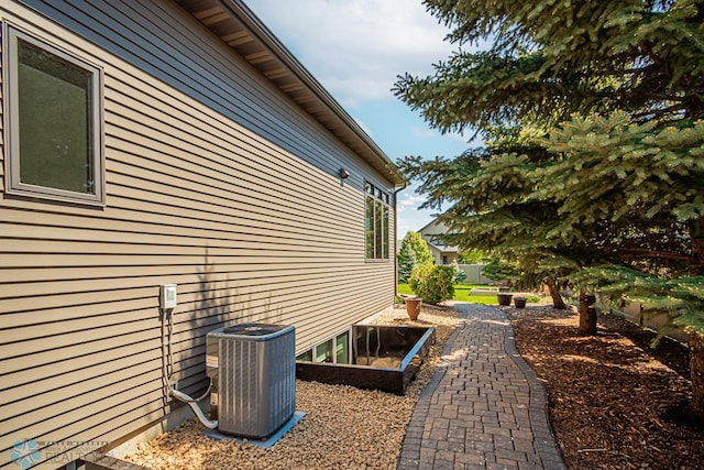 view of side of home with central AC unit