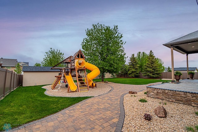 view of playground featuring a patio area and a yard