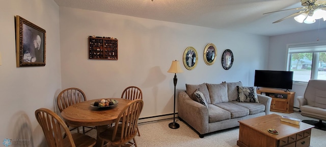 living room with light carpet, baseboard heating, ceiling fan, and a textured ceiling