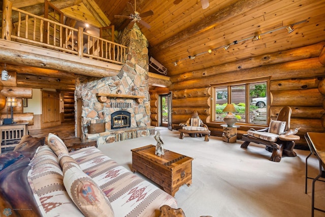 carpeted living room featuring high vaulted ceiling, log walls, wooden ceiling, rail lighting, and a fireplace