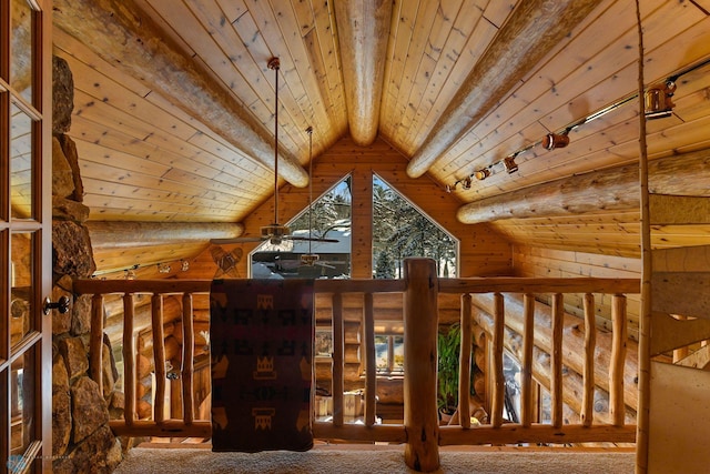 interior space featuring carpet, rustic walls, lofted ceiling with beams, and wood ceiling