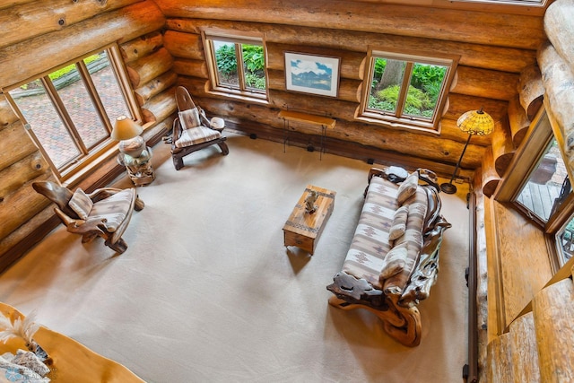 living room with a wealth of natural light and rustic walls