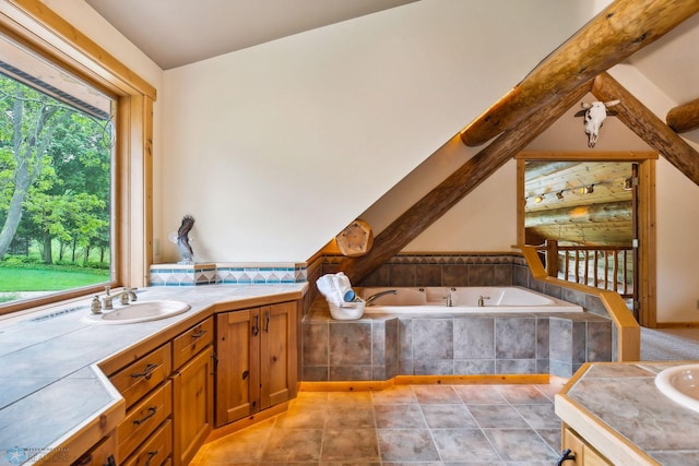 bathroom with tile patterned flooring, lofted ceiling, tiled bath, and vanity