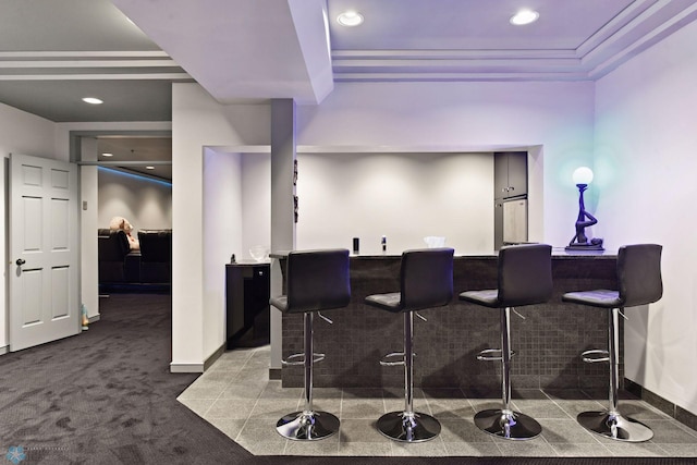 bar with carpet flooring and a raised ceiling