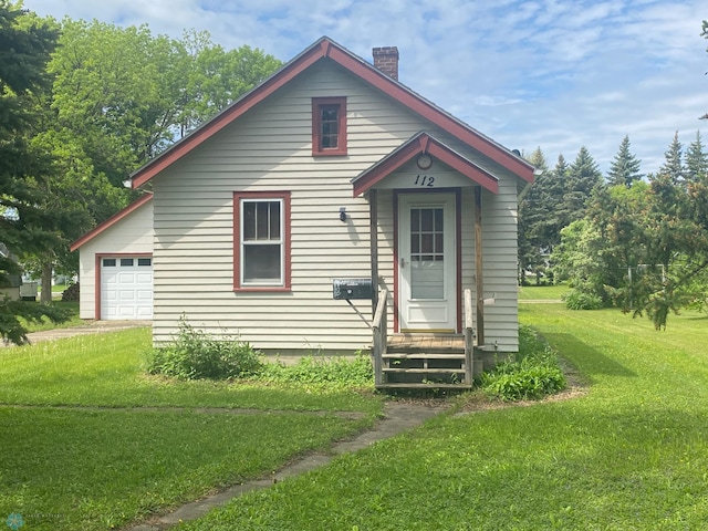 view of front of house with a garage and a front yard