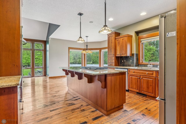 kitchen with a center island, plenty of natural light, and light hardwood / wood-style flooring