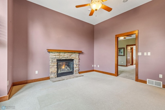 carpeted living room with a fireplace and ceiling fan