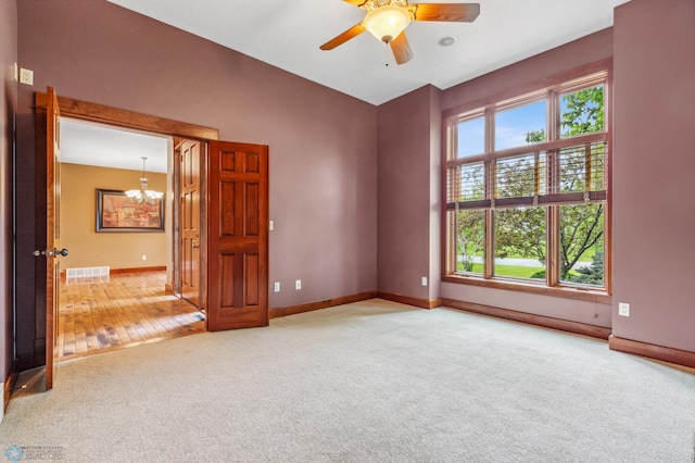 unfurnished room featuring carpet and a wealth of natural light