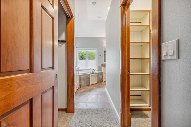 hallway with light tile floors