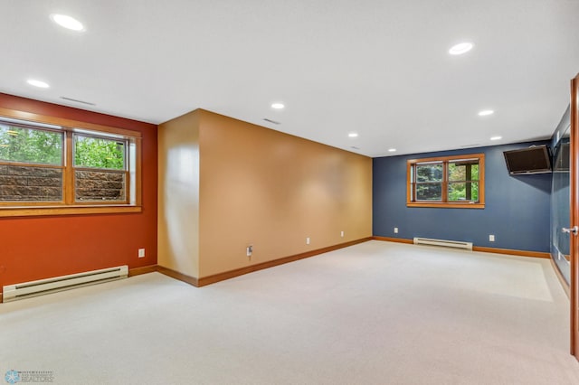 unfurnished room with carpet and a baseboard radiator