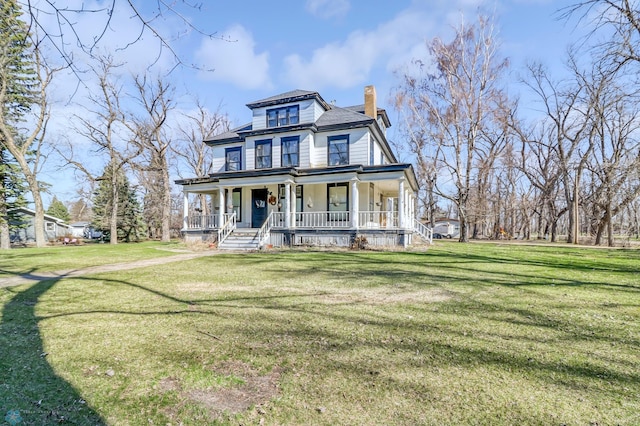 view of front facade with a front yard and covered porch