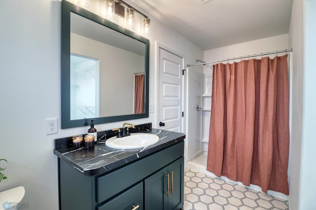 bathroom with tile floors, toilet, and vanity