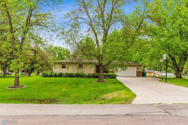 view of front of property with a front yard and a garage