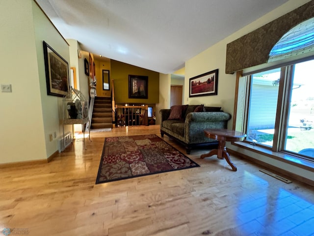 living room with lofted ceiling and light wood-type flooring