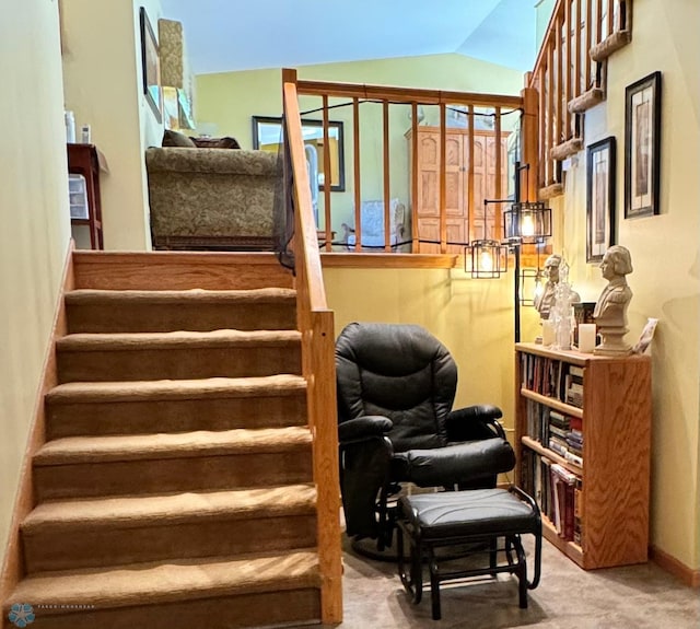 stairs featuring lofted ceiling, carpet flooring, and a wealth of natural light