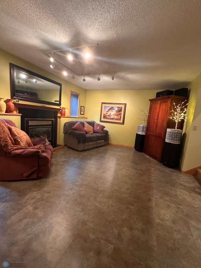 living room featuring track lighting and a textured ceiling