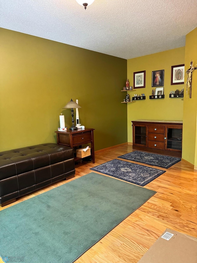 living room with hardwood / wood-style floors and a textured ceiling