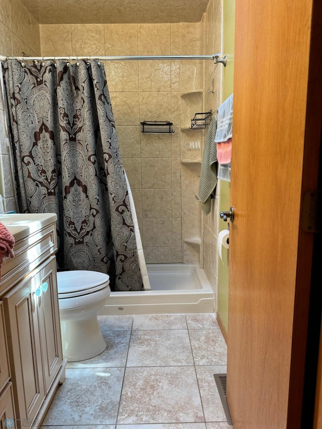 bathroom featuring vanity, tile patterned floors, toilet, and a shower with shower curtain