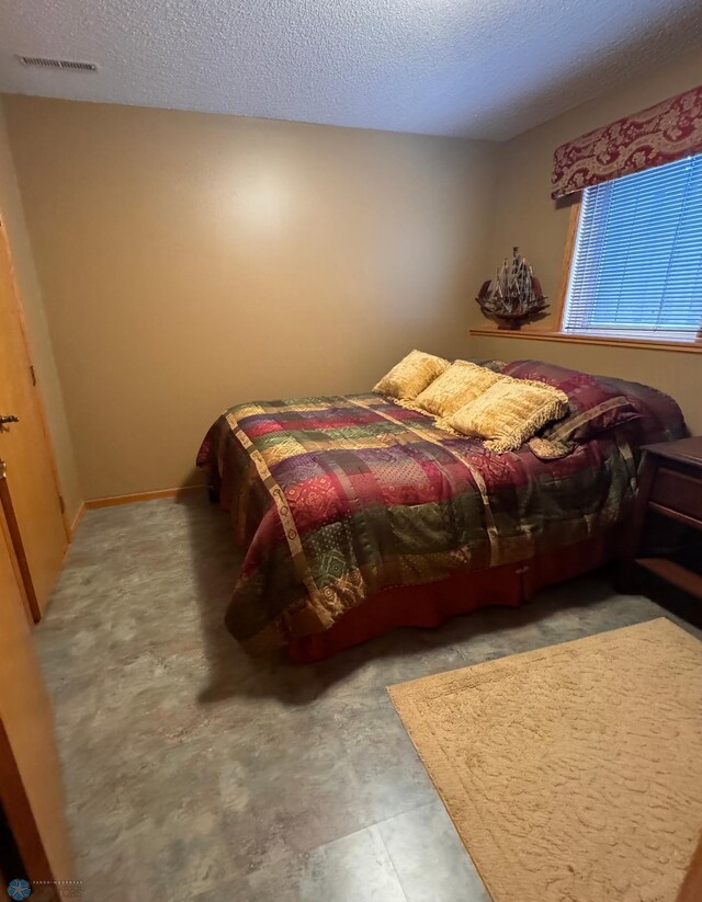 bedroom featuring a textured ceiling