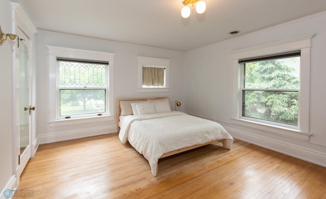 bedroom featuring light hardwood / wood-style floors and multiple windows