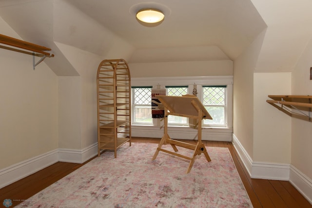 living area featuring lofted ceiling and hardwood / wood-style floors