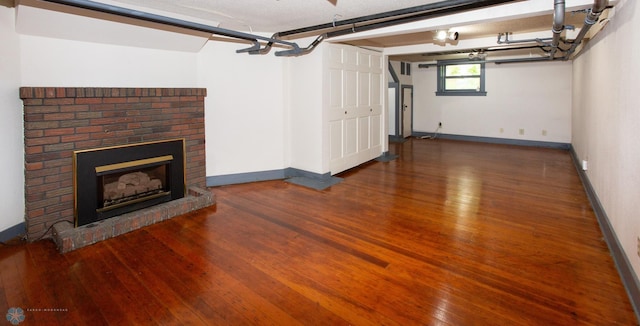 interior space featuring dark hardwood / wood-style floors and a brick fireplace