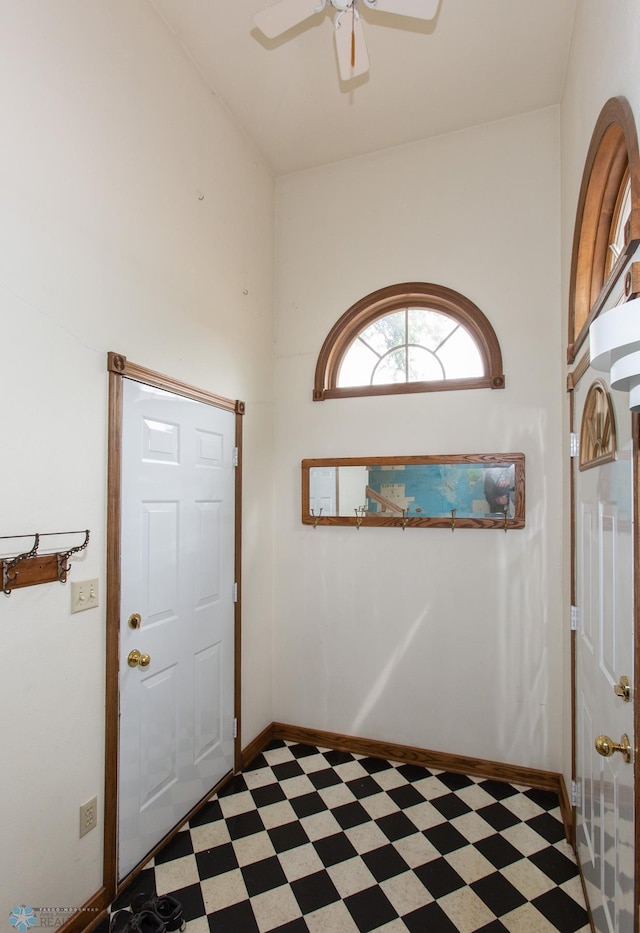 entryway featuring light tile patterned floors and ceiling fan