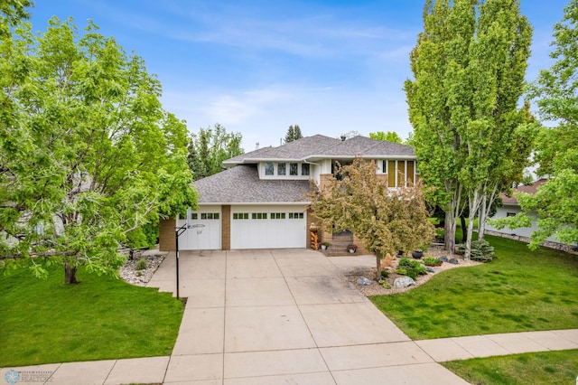 view of front of home featuring a garage and a front lawn