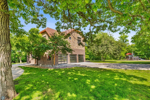 view of front facade with a front yard and a garage