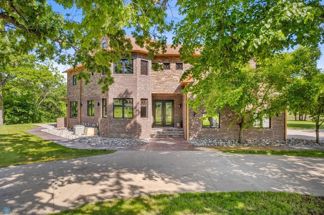 view of front of house featuring a front yard and central AC