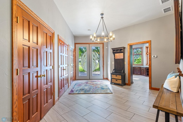 entrance foyer featuring french doors, plenty of natural light, and light tile floors