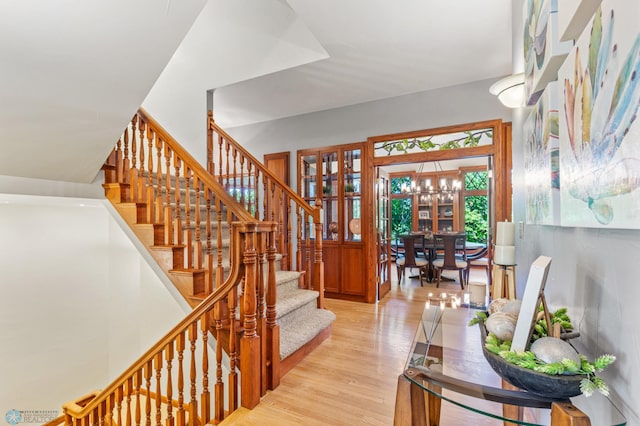 staircase with hardwood / wood-style flooring