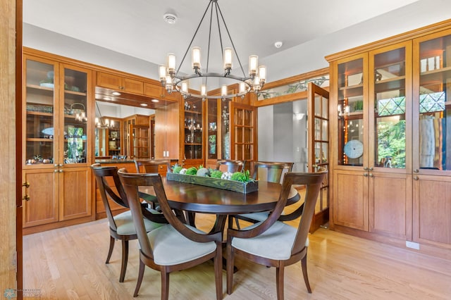 dining room featuring plenty of natural light, light hardwood / wood-style floors, and a chandelier