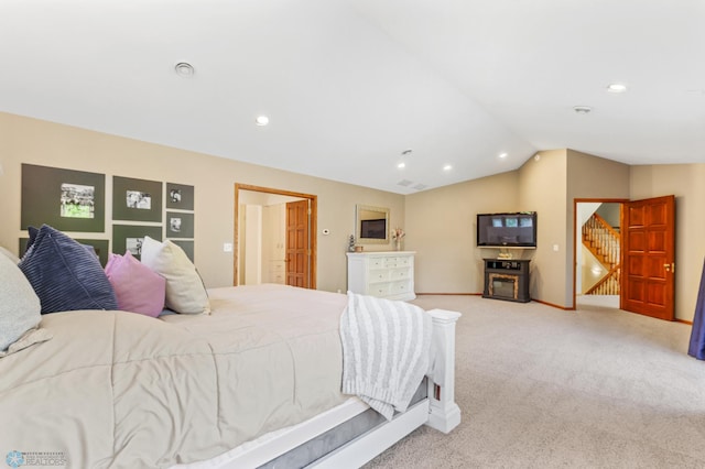 bedroom with carpet floors and vaulted ceiling