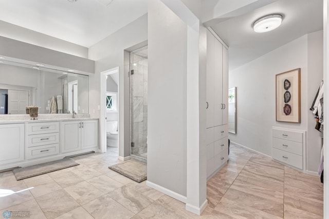 bathroom with tile floors, an enclosed shower, double vanity, and toilet