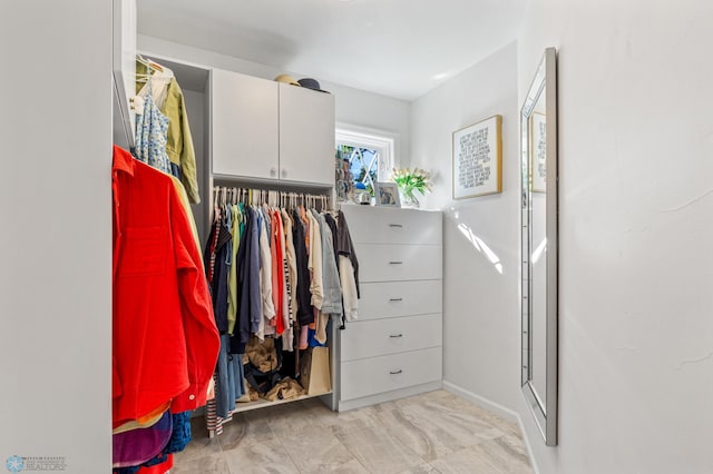 walk in closet featuring light tile flooring