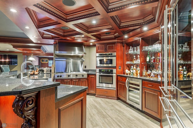 kitchen with wall chimney range hood, coffered ceiling, beverage cooler, and stainless steel double oven