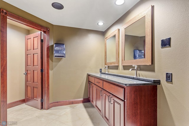 bathroom featuring tile floors and vanity