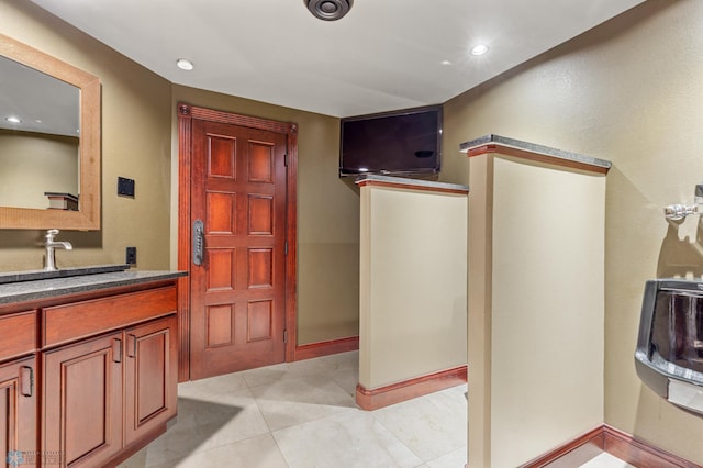 bathroom featuring tile floors and vanity