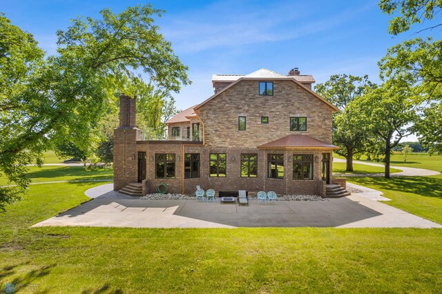 rear view of house featuring a lawn