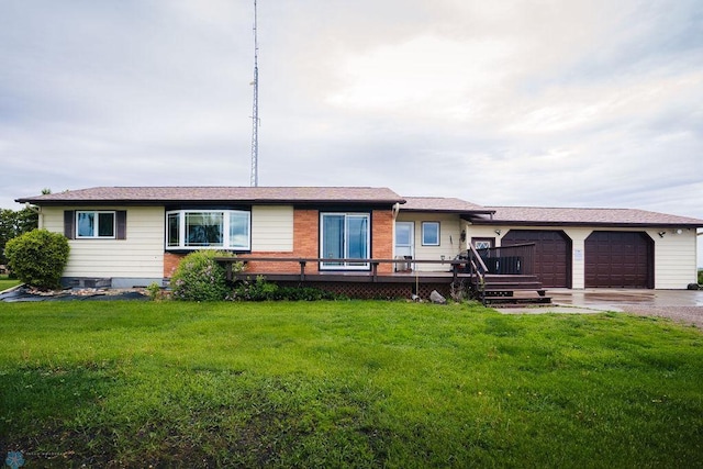 ranch-style house featuring a garage, a front yard, and a wooden deck