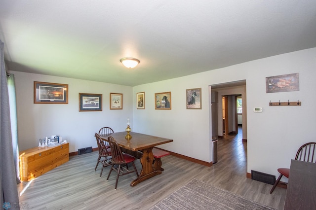 dining area with hardwood / wood-style floors